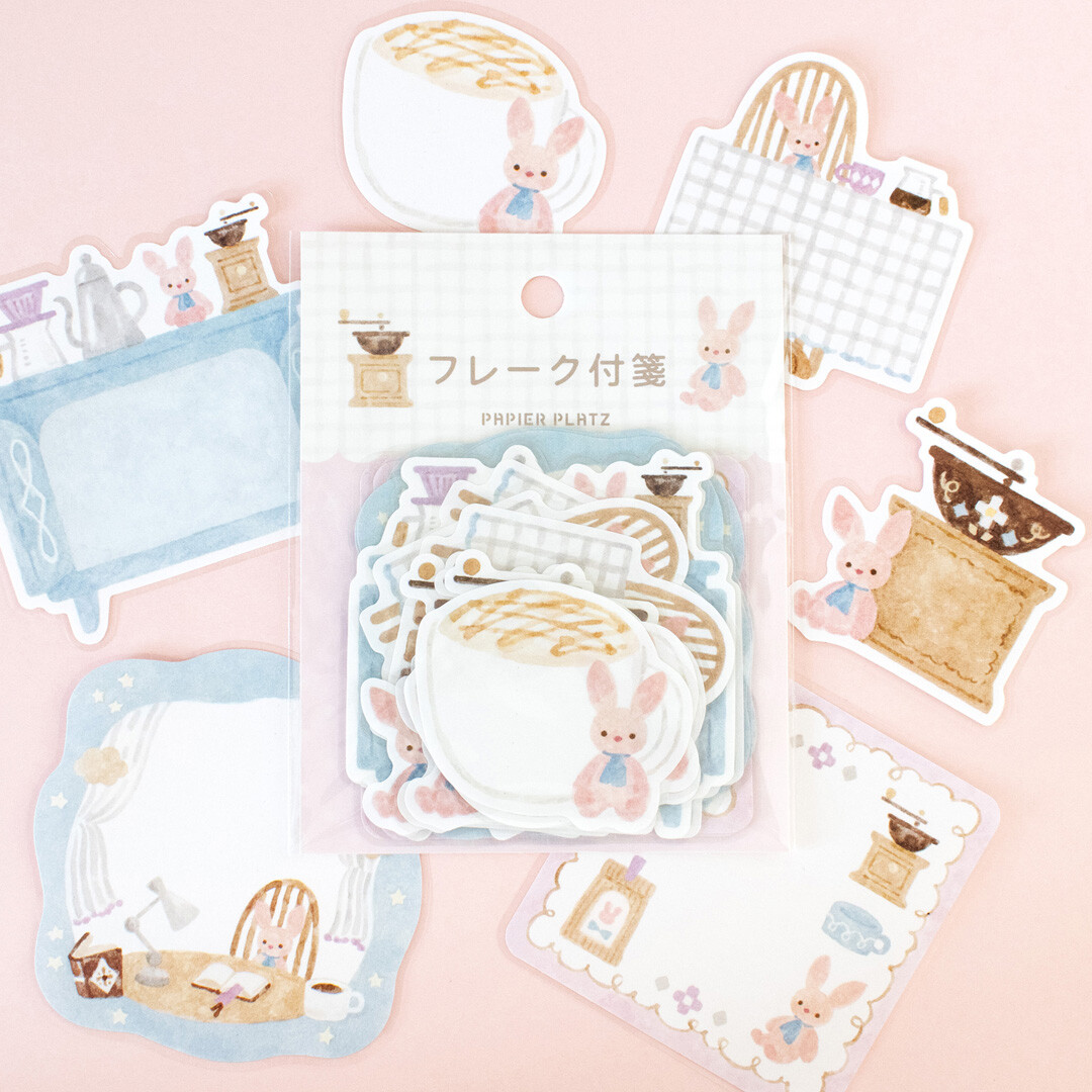 Papier Platz Rabbit’s Café stickers displayed on a soft pink background, featuring illustrated rabbits with coffee cups, tables, kitchen furniture, notebooks, and café accessories in a pastel watercolour style.